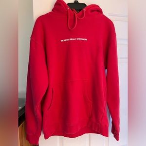 Red Sweatshirt “WE’RE NOT REALLY STRANGERS”